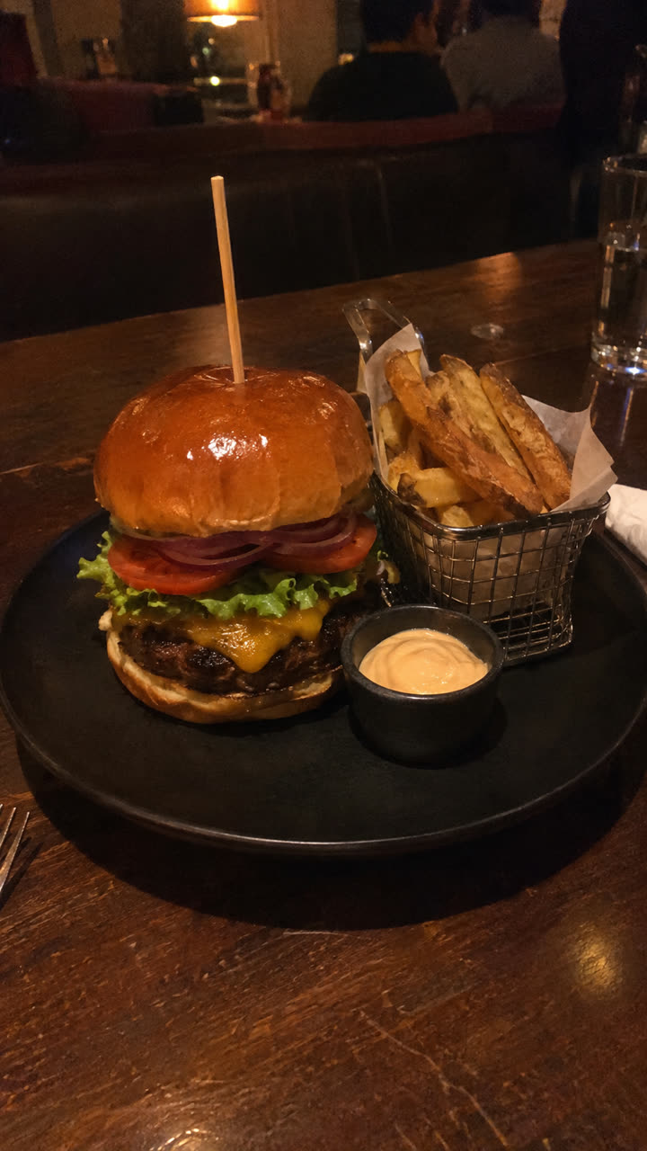 Photo of a smash cheeseburger in a brioche bun
